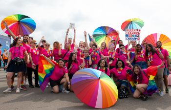 A group wearing Ƶ-branded pink T-Shirts gathers at the start of Pride 2019