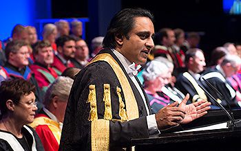 The Chancellor of Ƶ stands at the lectern during a ceremony