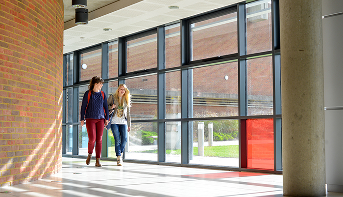 Two PhD students walk through the School of Business, Management and Economic's Jubilee building at the Ƶ